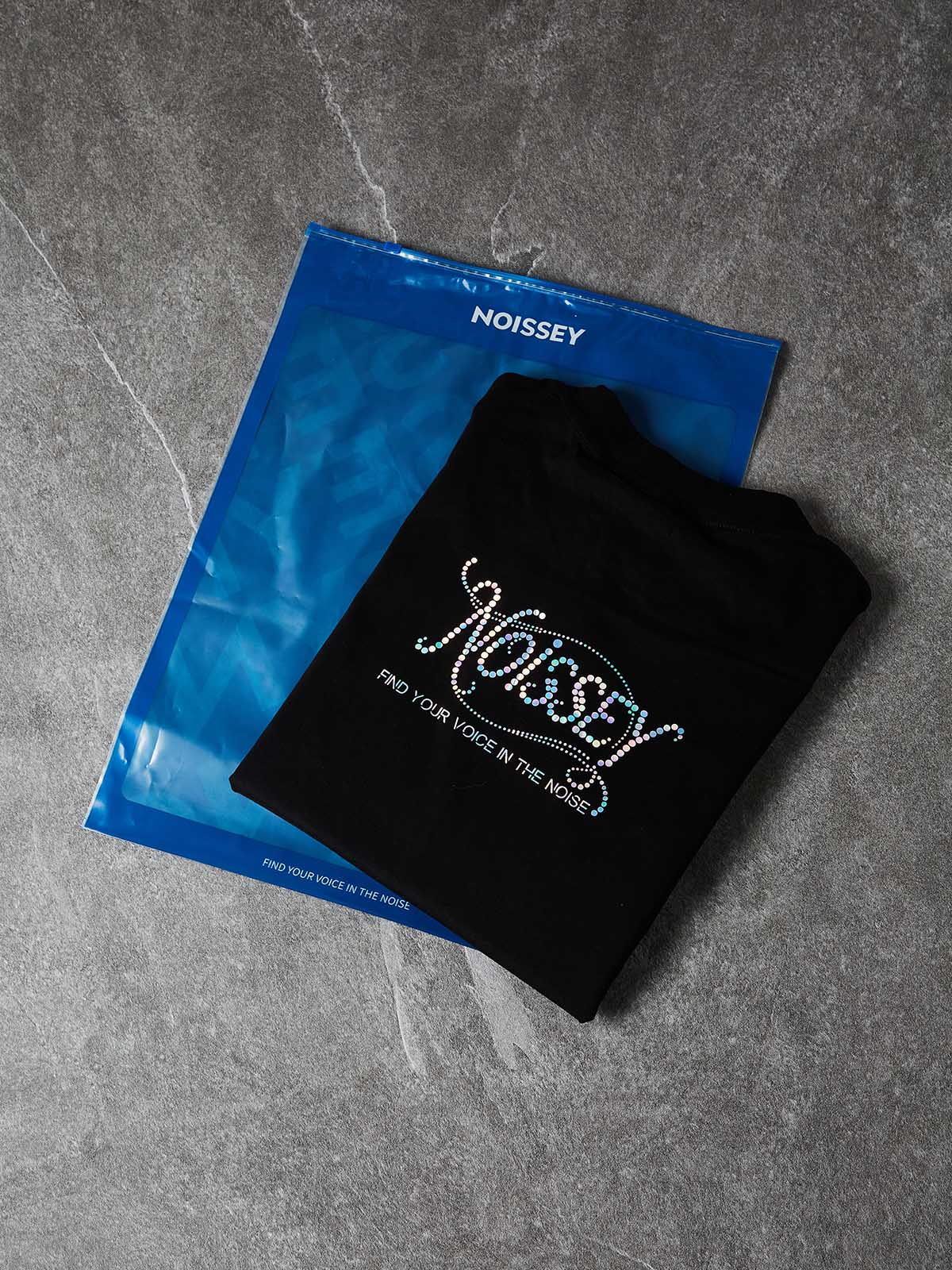 NOISSEY SHIMMER LOGO - SILVER CURSIVE SLOGAN TEE