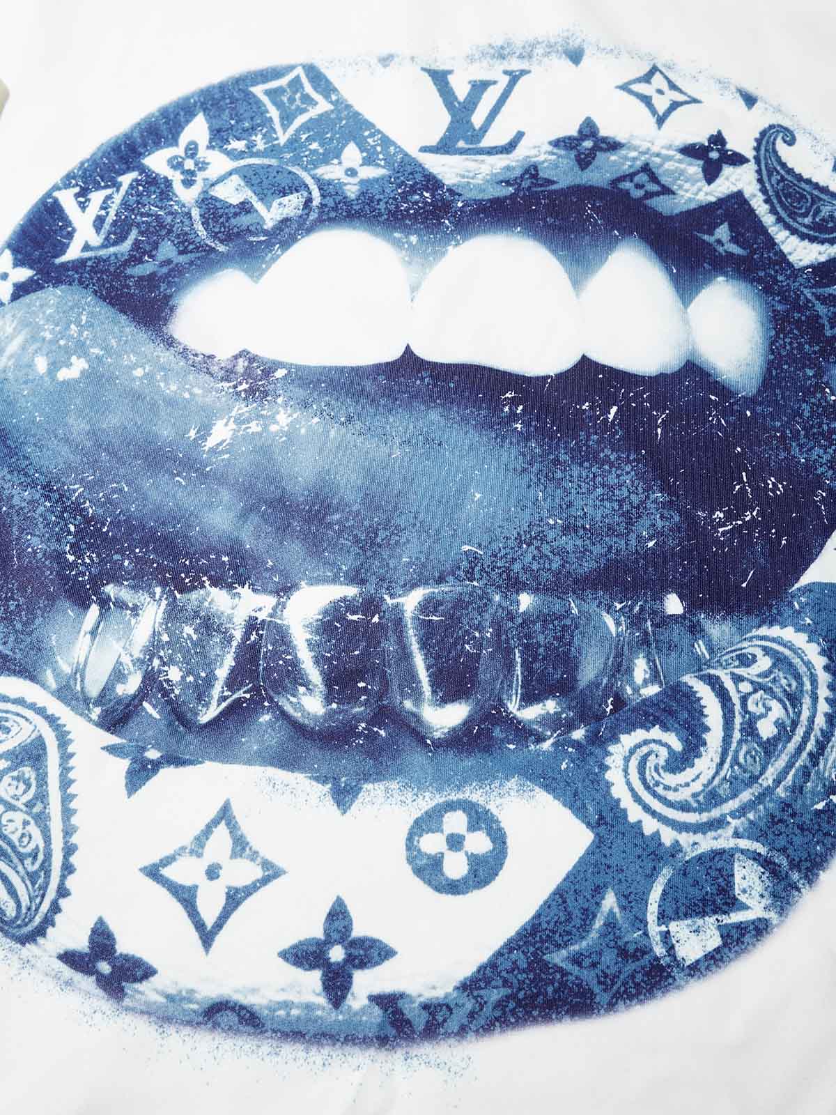 Close-up of blue lips graphic filled with paisley bandana pattern and monogram details