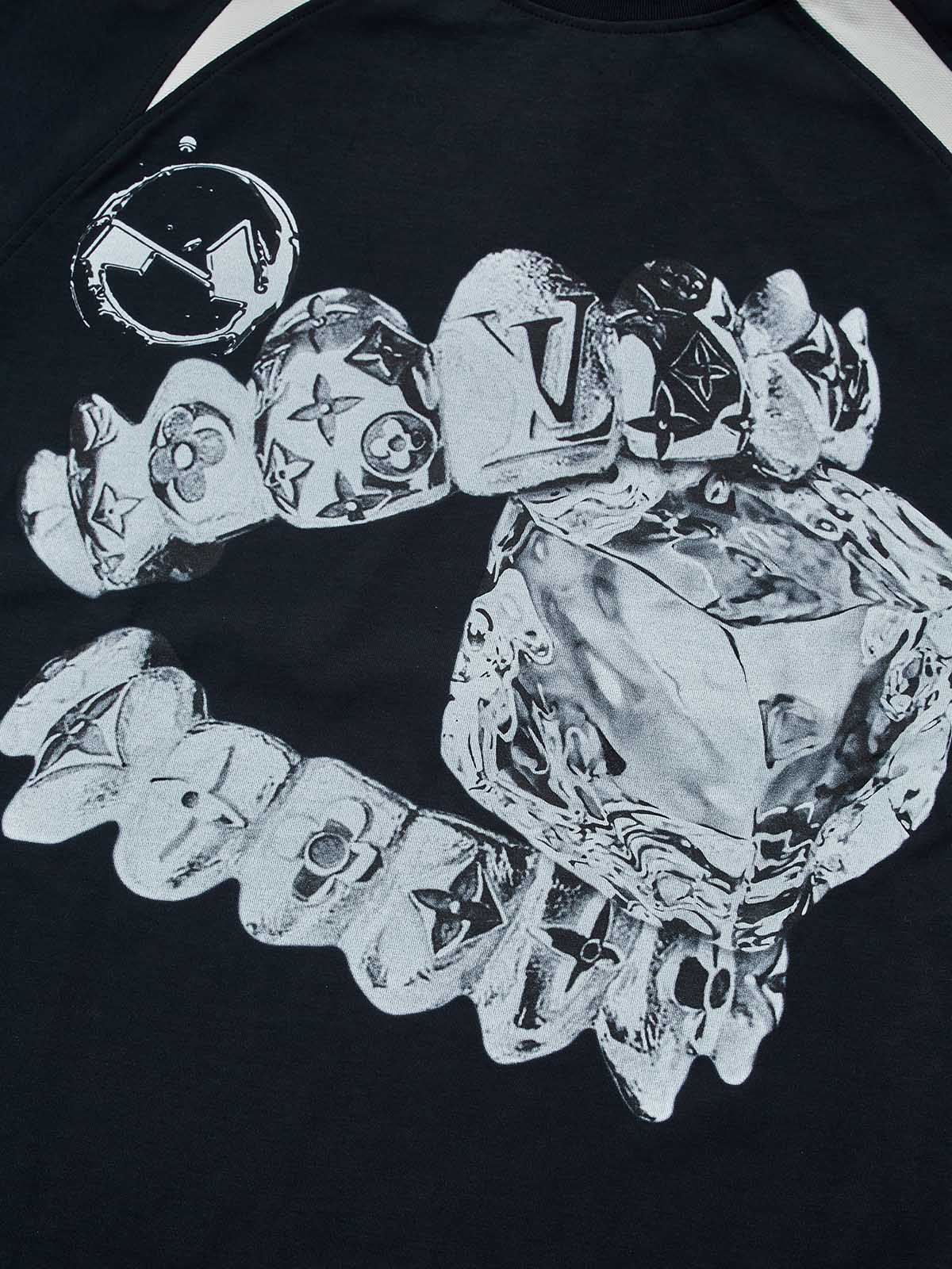 Close-up of metallic liquid chrome texture and monogram grillz graphic on breathable cooling fabric.