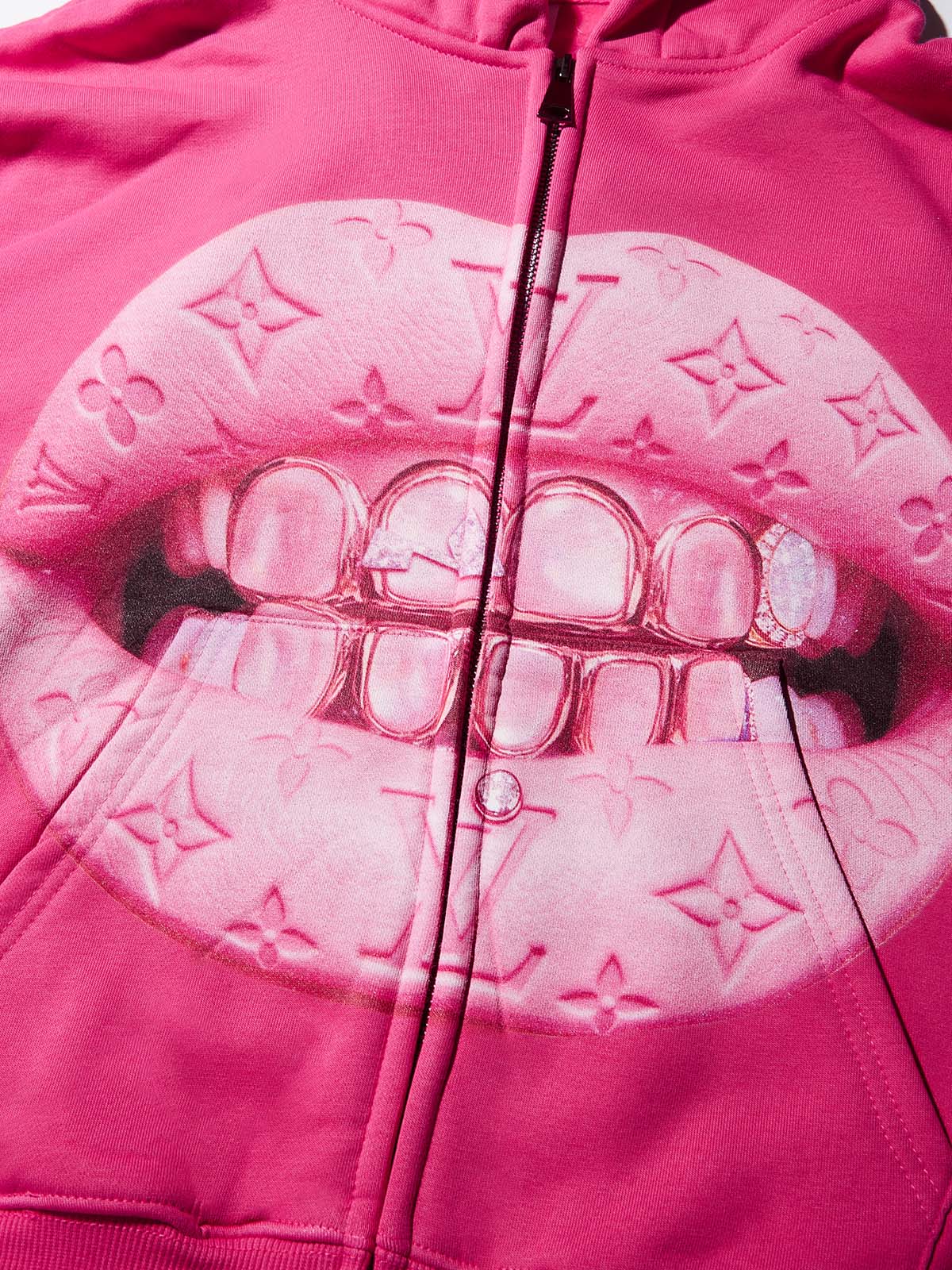 Close-up of pink lips graphic with faux-leather monogram texture and gold grillz