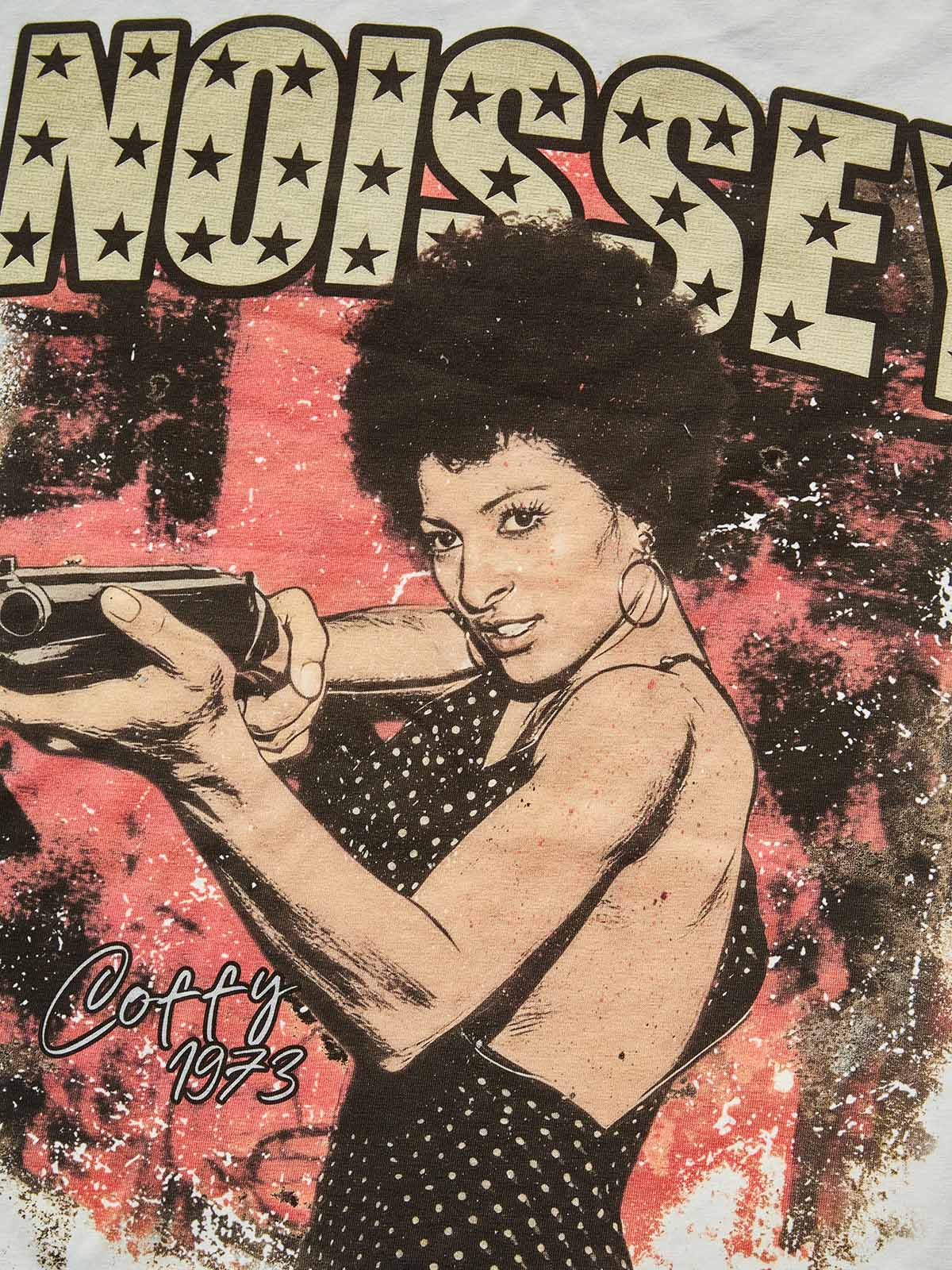 Close-up of the "Coffy 1973" signature and the distressed red paint-splatter effect in the background of the print.
