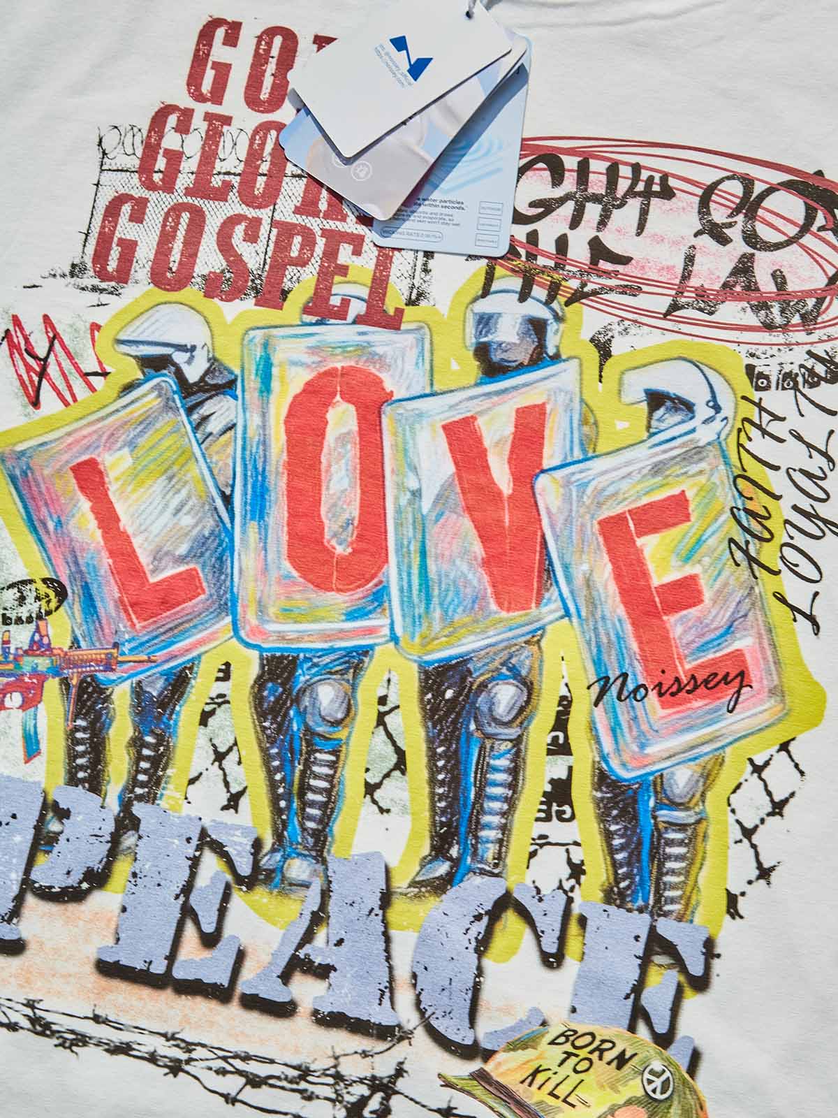 Close-up of the "LOVE" typography and the detailed riot shield graphic, highlighting the textured paint-stroke effects.
