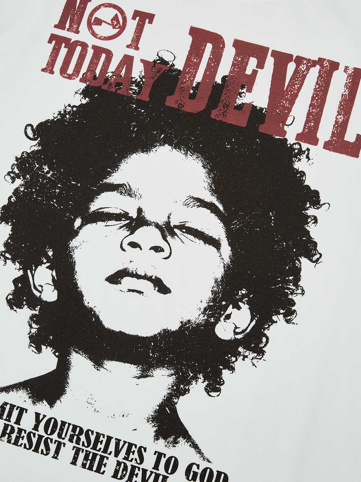 Close-up of the distressed red "DEVIL" lettering and the vintage halftone portrait print on the fabric.