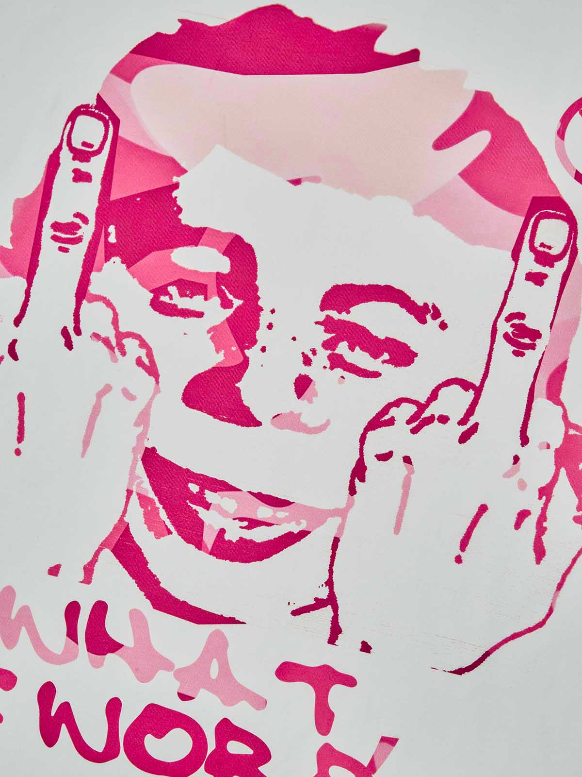 Close-up of the vibrant pink camouflage print and "What Me Worry?" typography, showing fabric texture and ink quality.