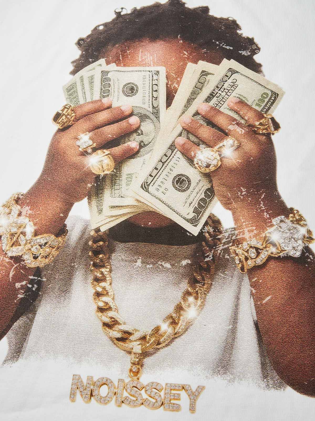 Close-up of young boy covering face with stack of money wearing gold jewelry and NOISSEY chain