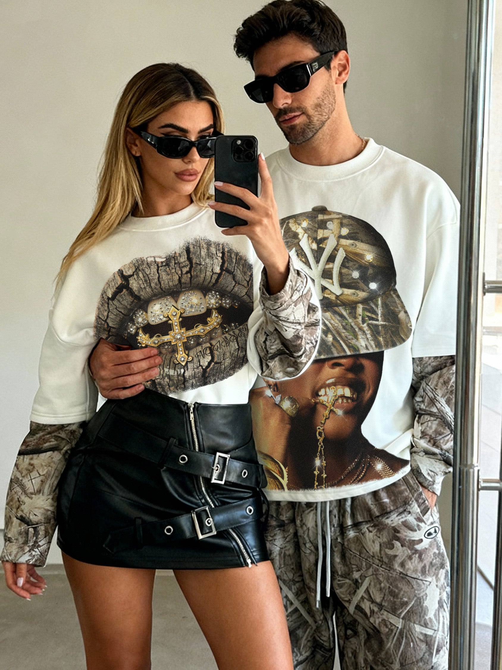 Couple wearing matching NOISSEY Real Tree camo layered shirts in a home setting