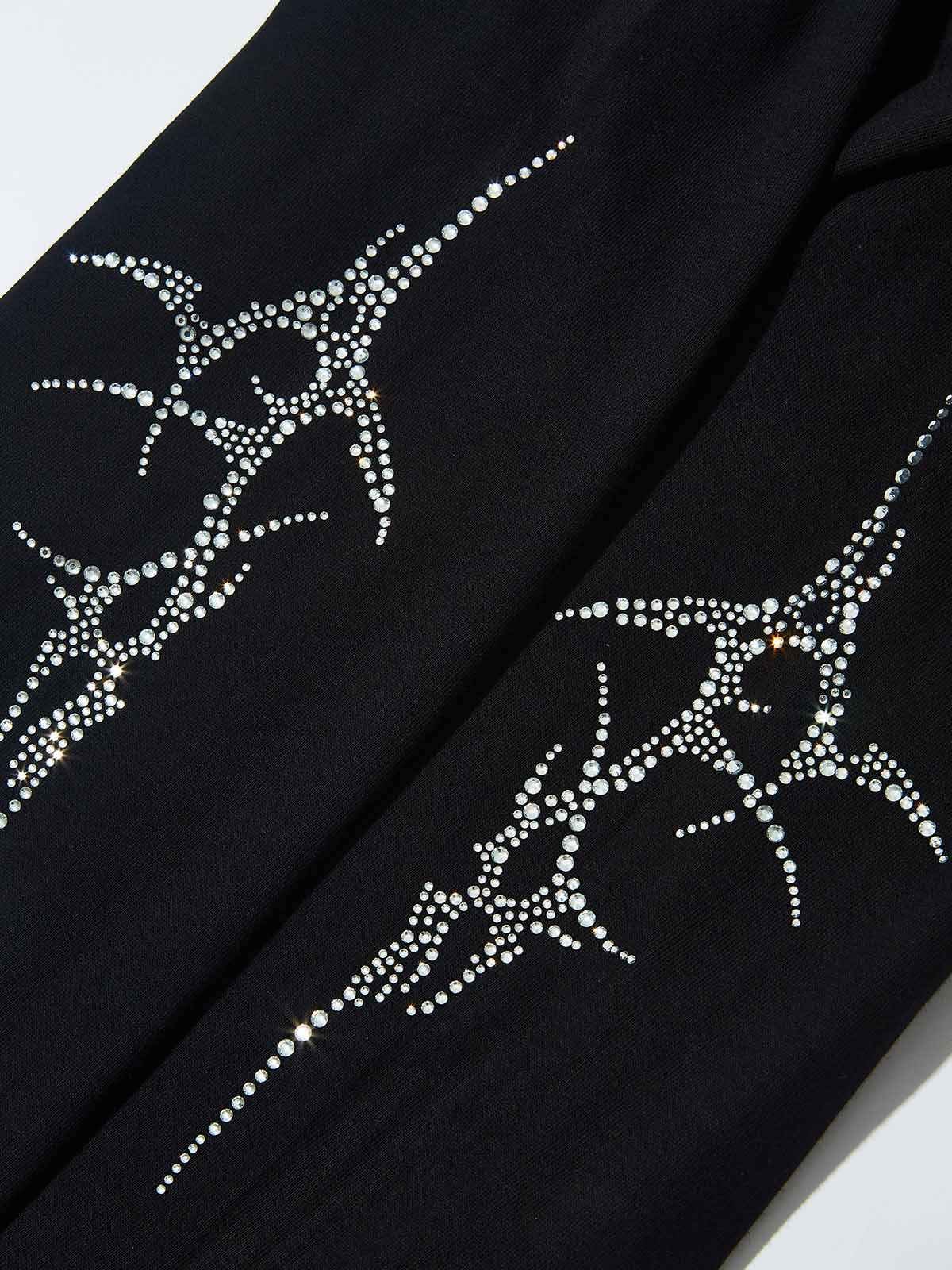 Detail of the sparkling rhinestone cyber thorn pattern on the black long sleeves