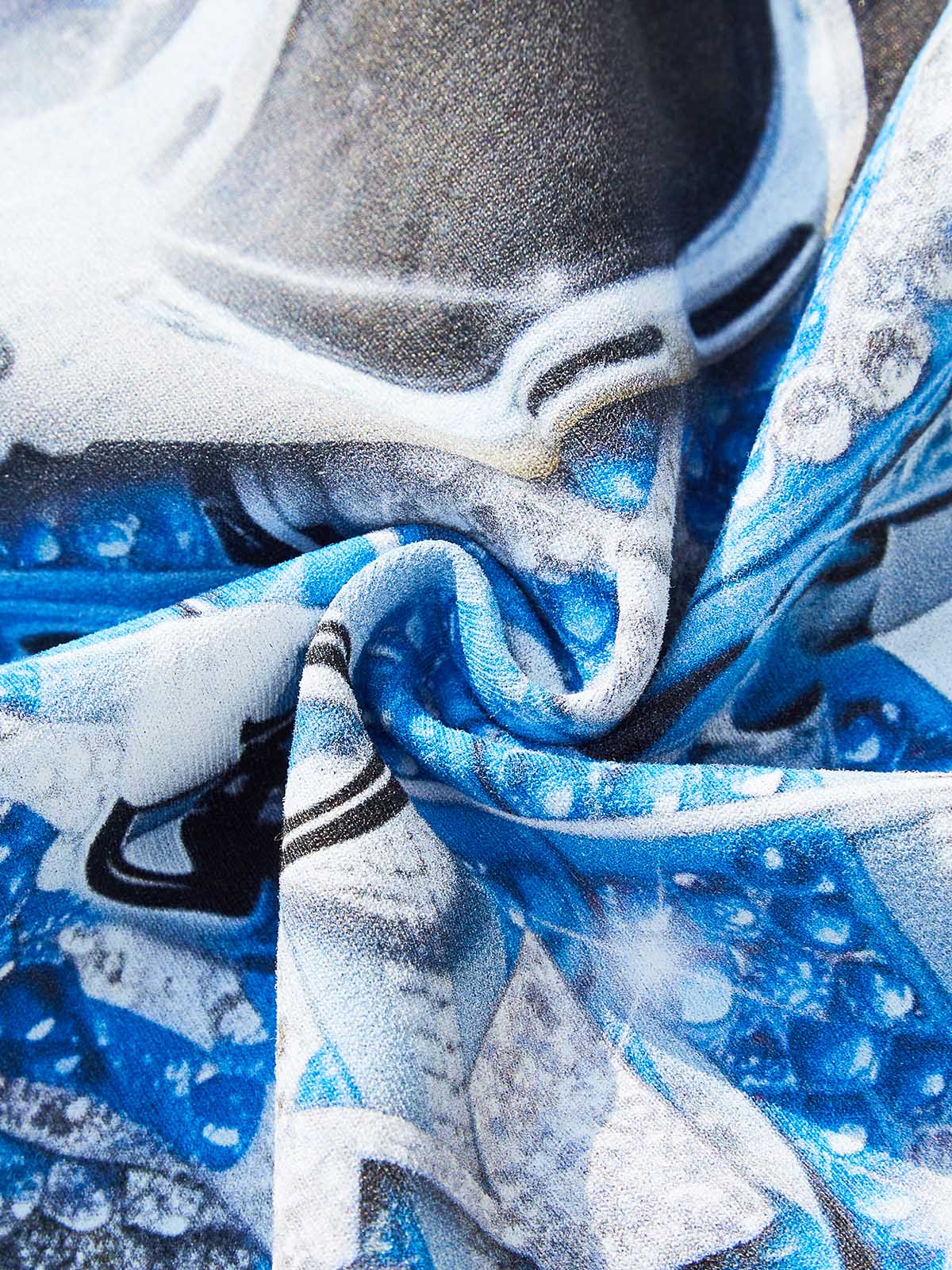 Detail showing the smooth texture of the printed graphic on soft blue cotton fabric