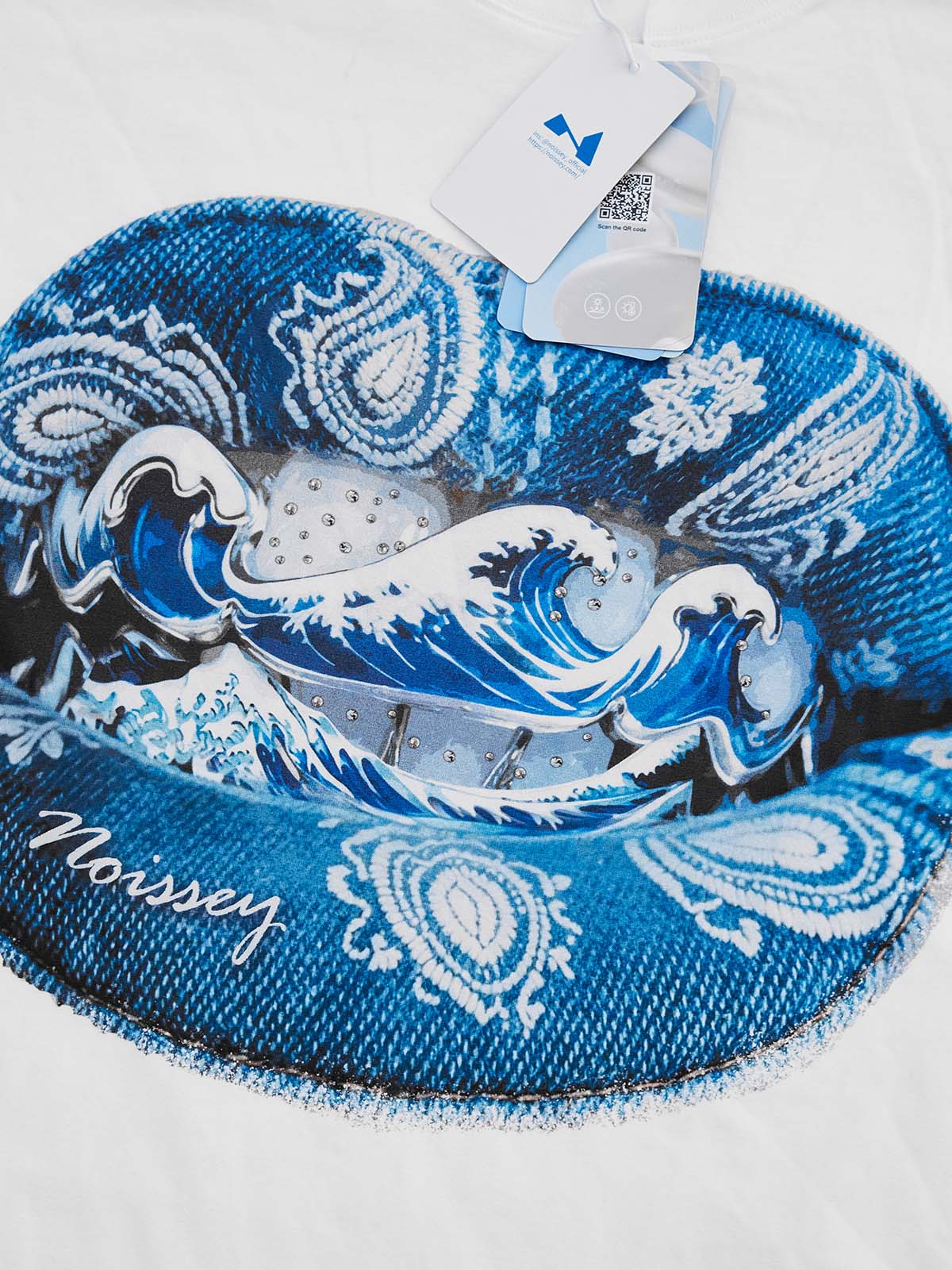 Extreme close-up of the Ukiyo-e print and grillz diamond detailing on the denim-colored fabric.