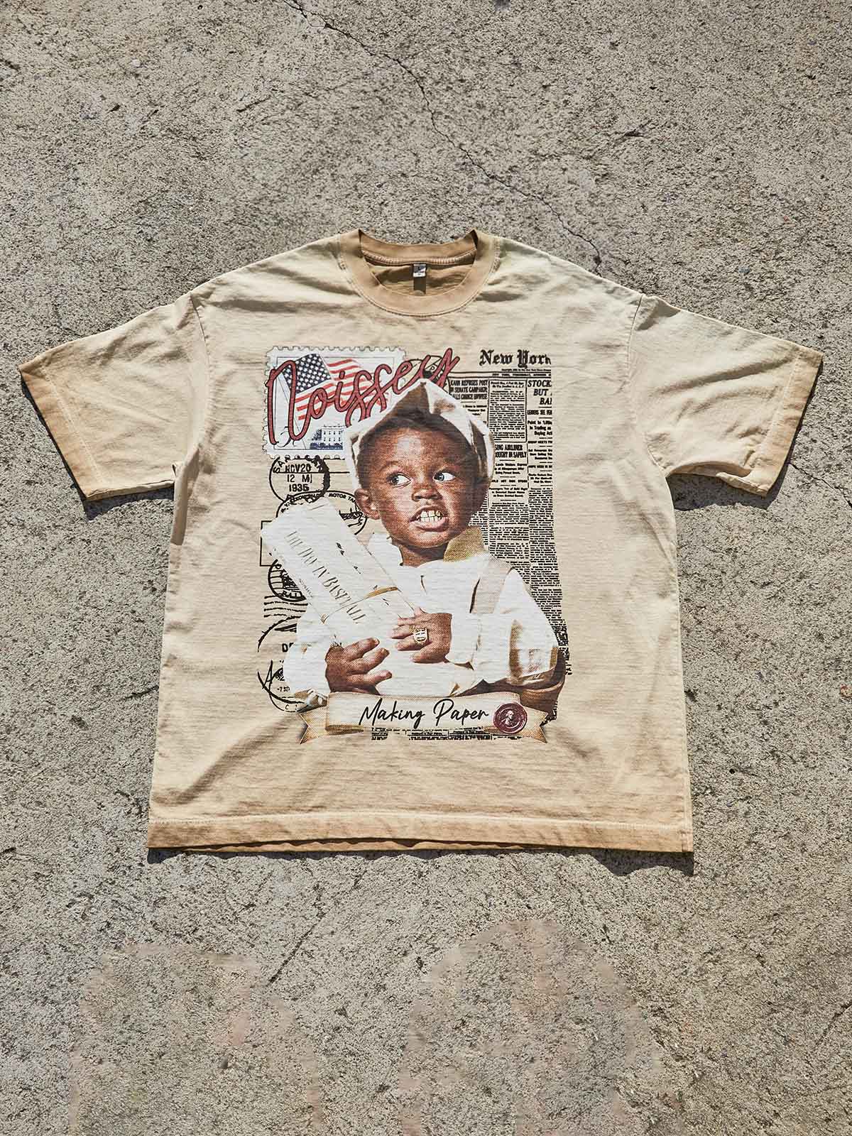 Flat lay of the Street Newsboy Art Print T-shirt in sand color showing the oversized streetwear silhouette.