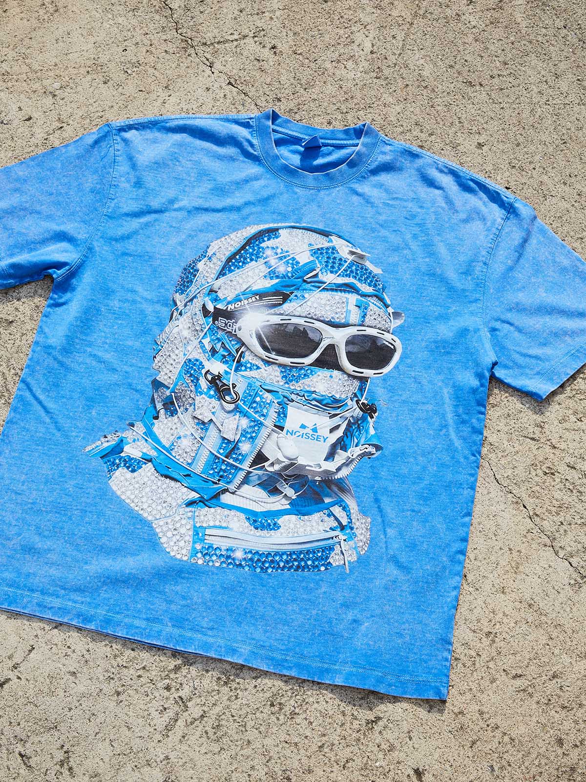 Flat lay of the blue streetwear tee showing the vintage wash color and clean fit