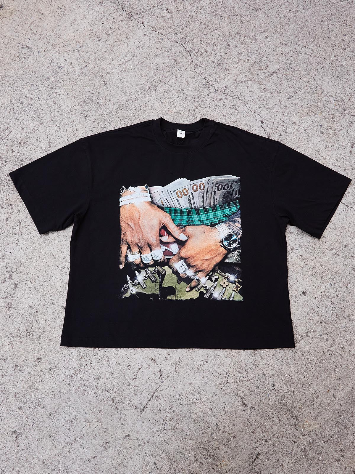 Flat lay of the white oversized graphic tee showing the boxy fit, short length, and wide body.