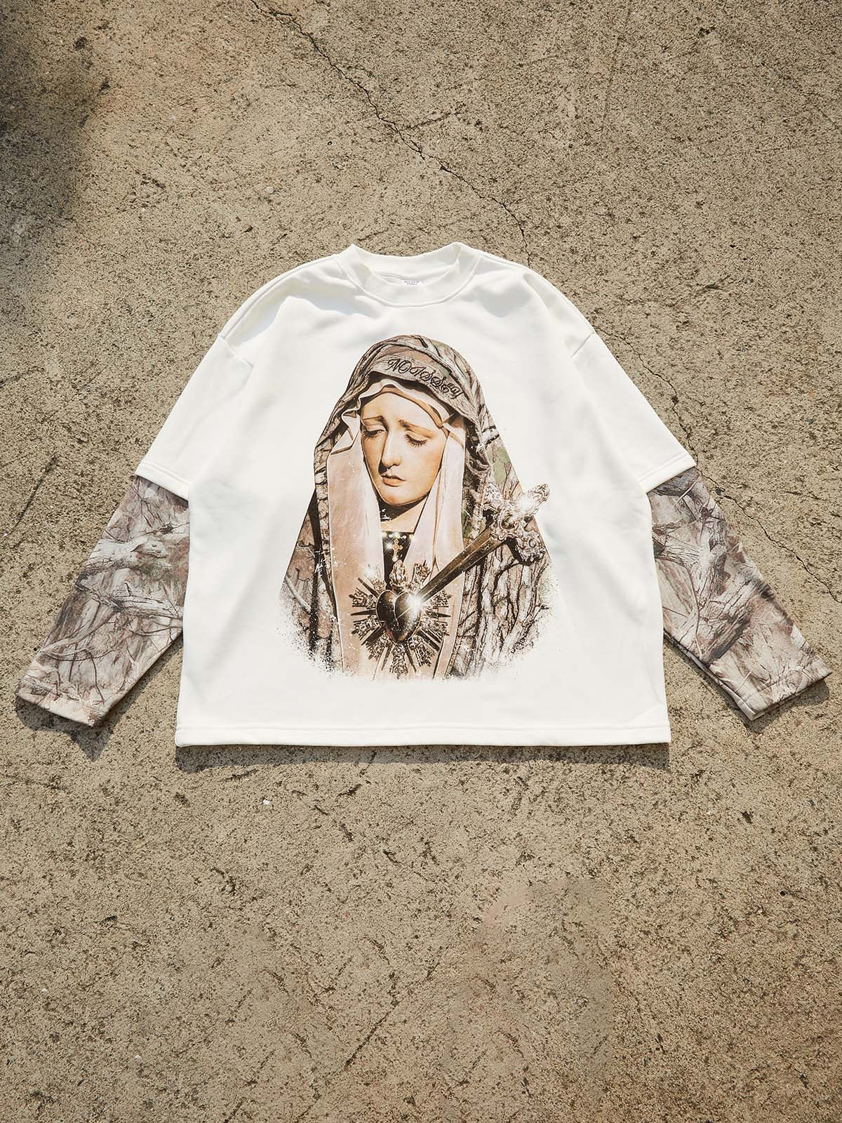 Flat lay of urban streetwear Madonna print sweatshirt in white with forest pattern sleeve details.