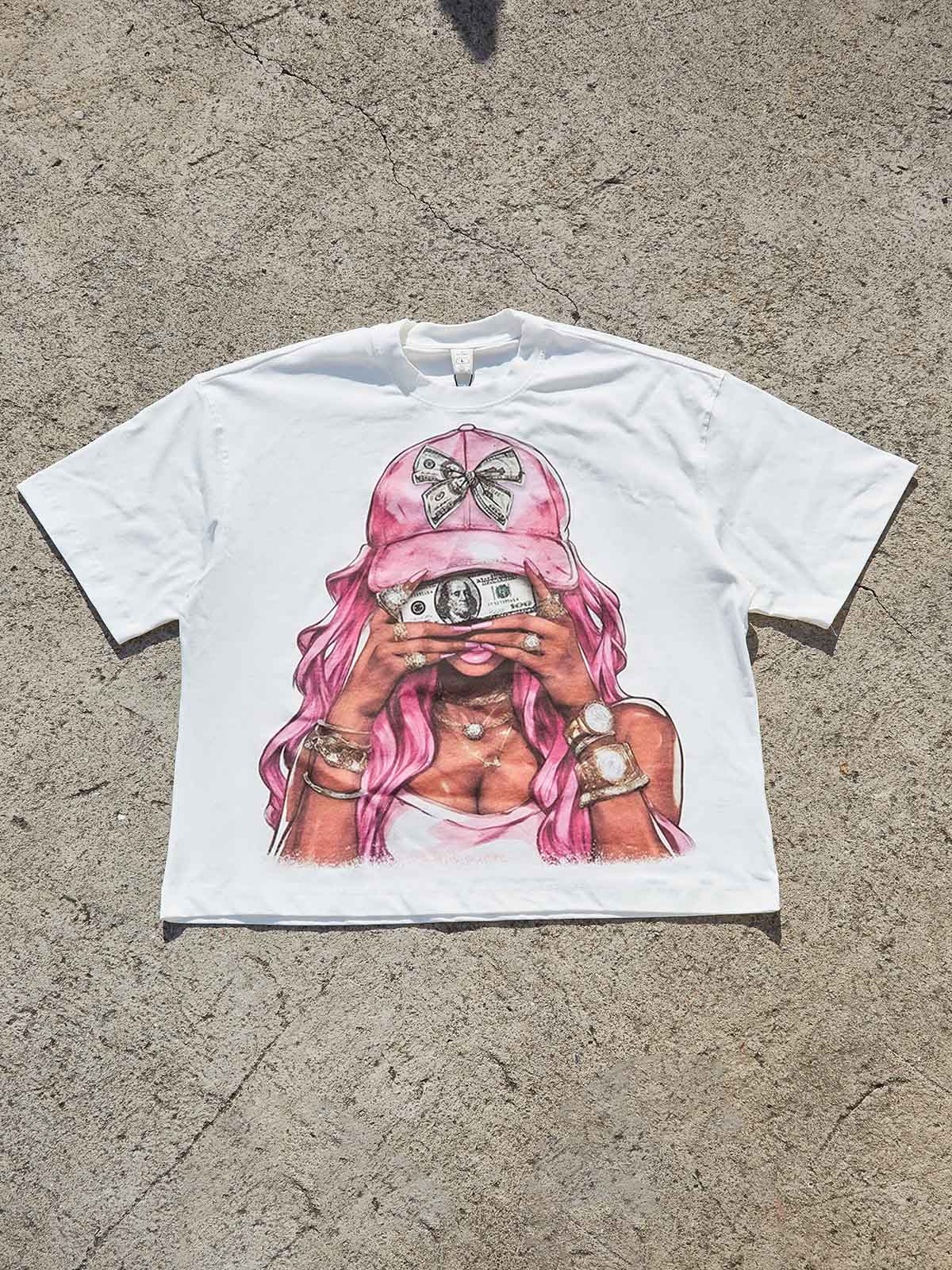 Flat lay of white cotton oversized streetwear tee with Money i$ the motive graphic print.