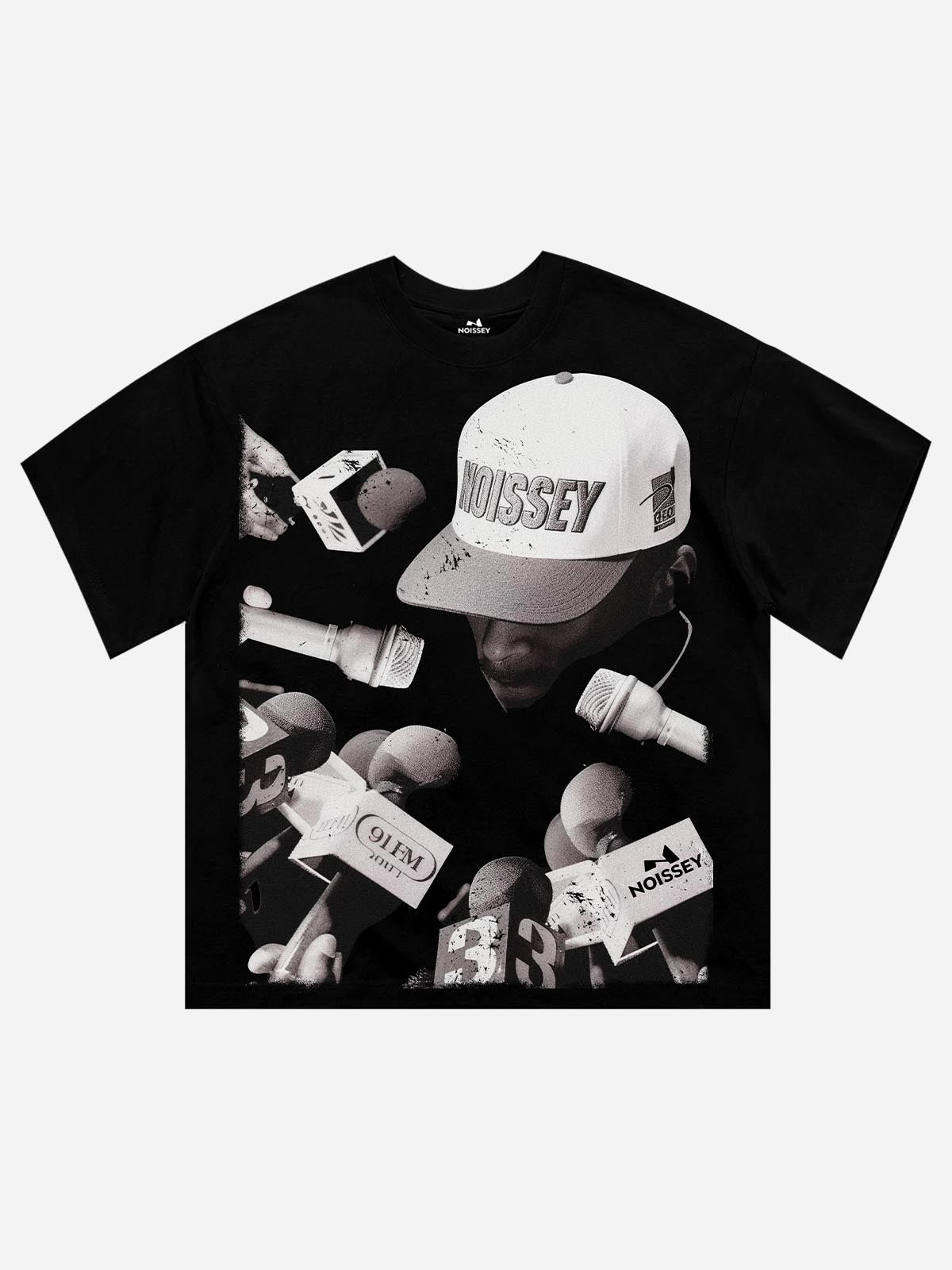 Front view of NOISSEY black t-shirt featuring a large monochrome graphic print of a person surrounded by press microphones and media reporters.