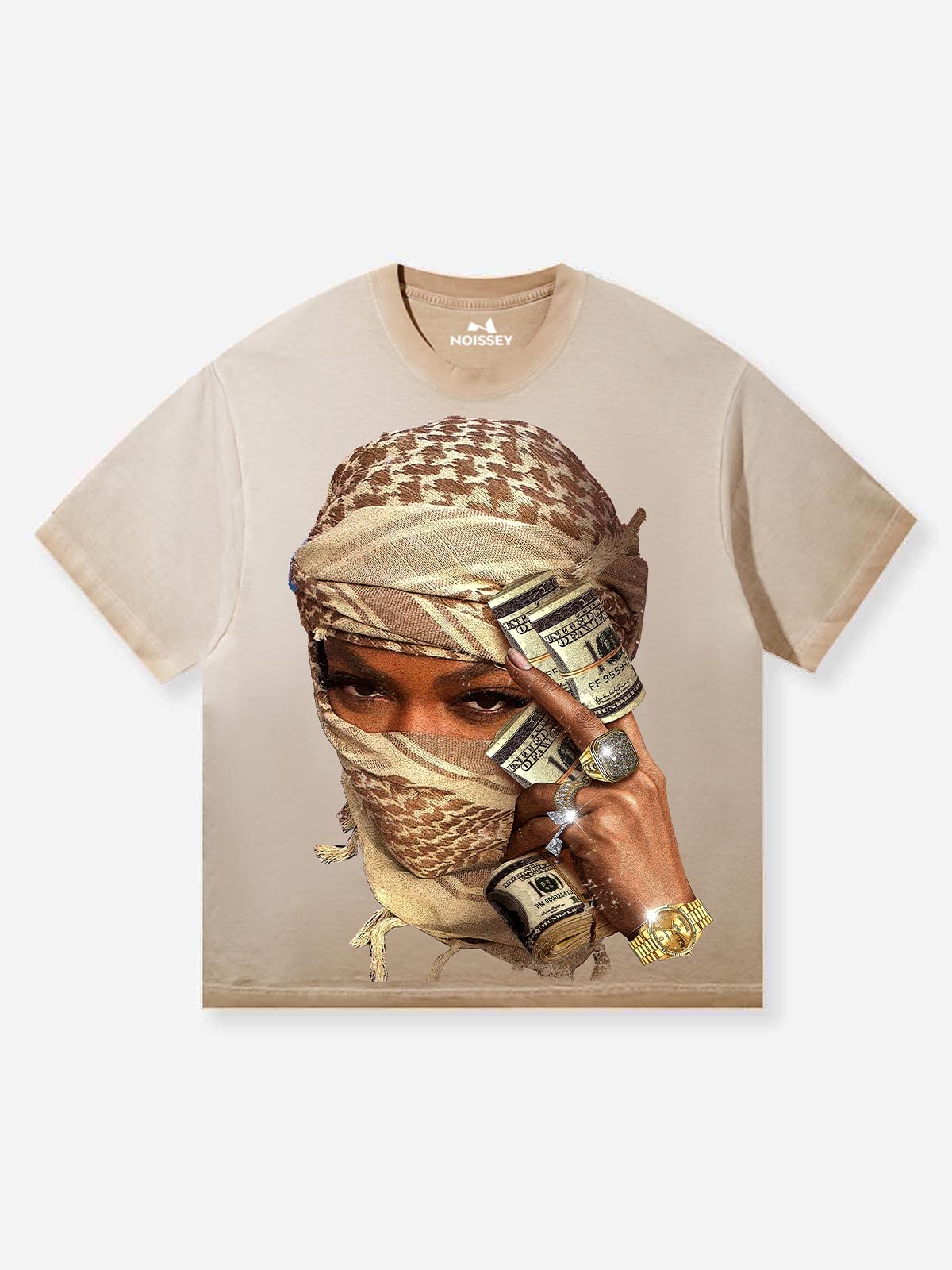 Front view of a NOISSEY tan streetwear T-shirt featuring a person in a desert shemagh holding money with sparkling crystal-studded rings and a gold watch.