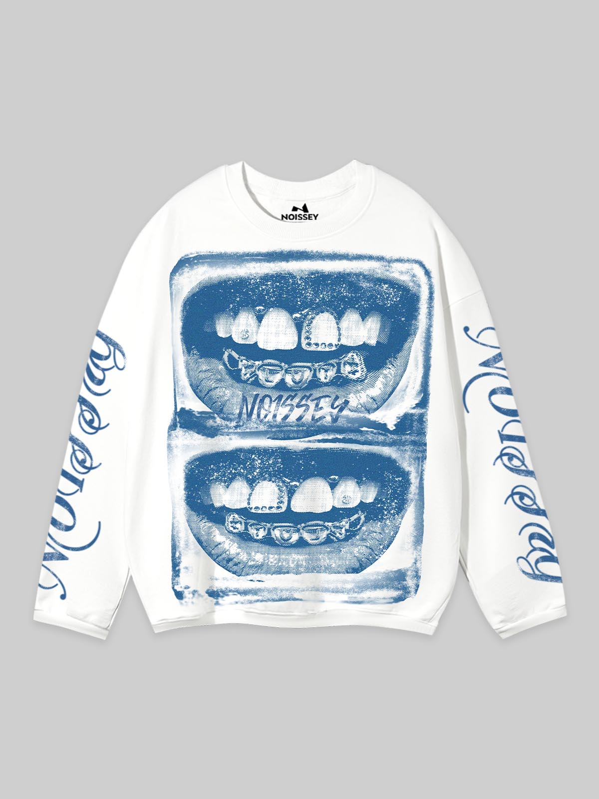 Front view of a white oversized long sleeve shirt featuring a stacked blue archival print of iced-out grillz and gothic sleeve lettering.