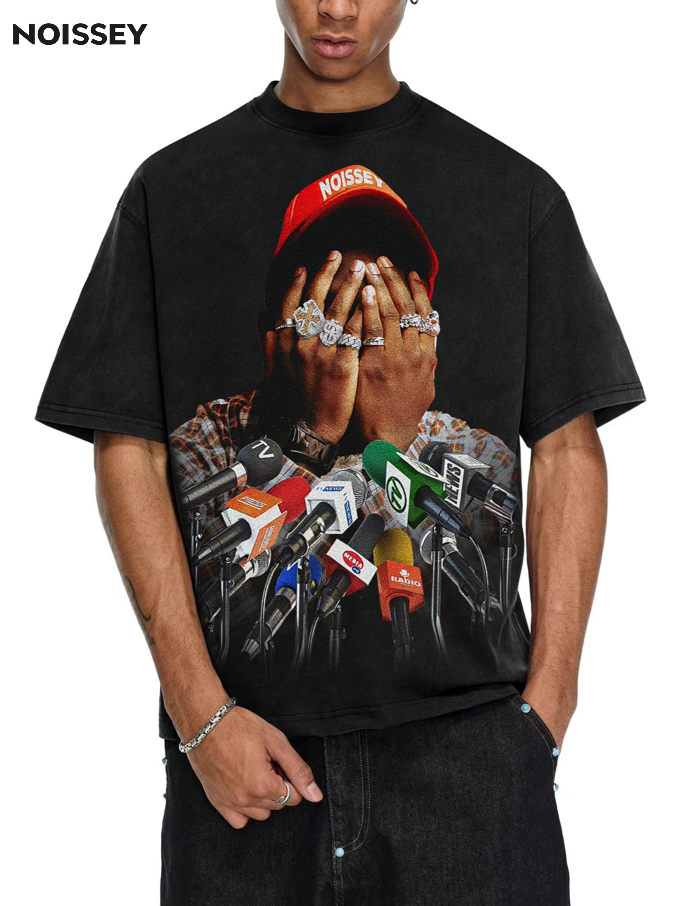 Male model wearing NOISSEY black boxy tee styled with brown cargo shorts