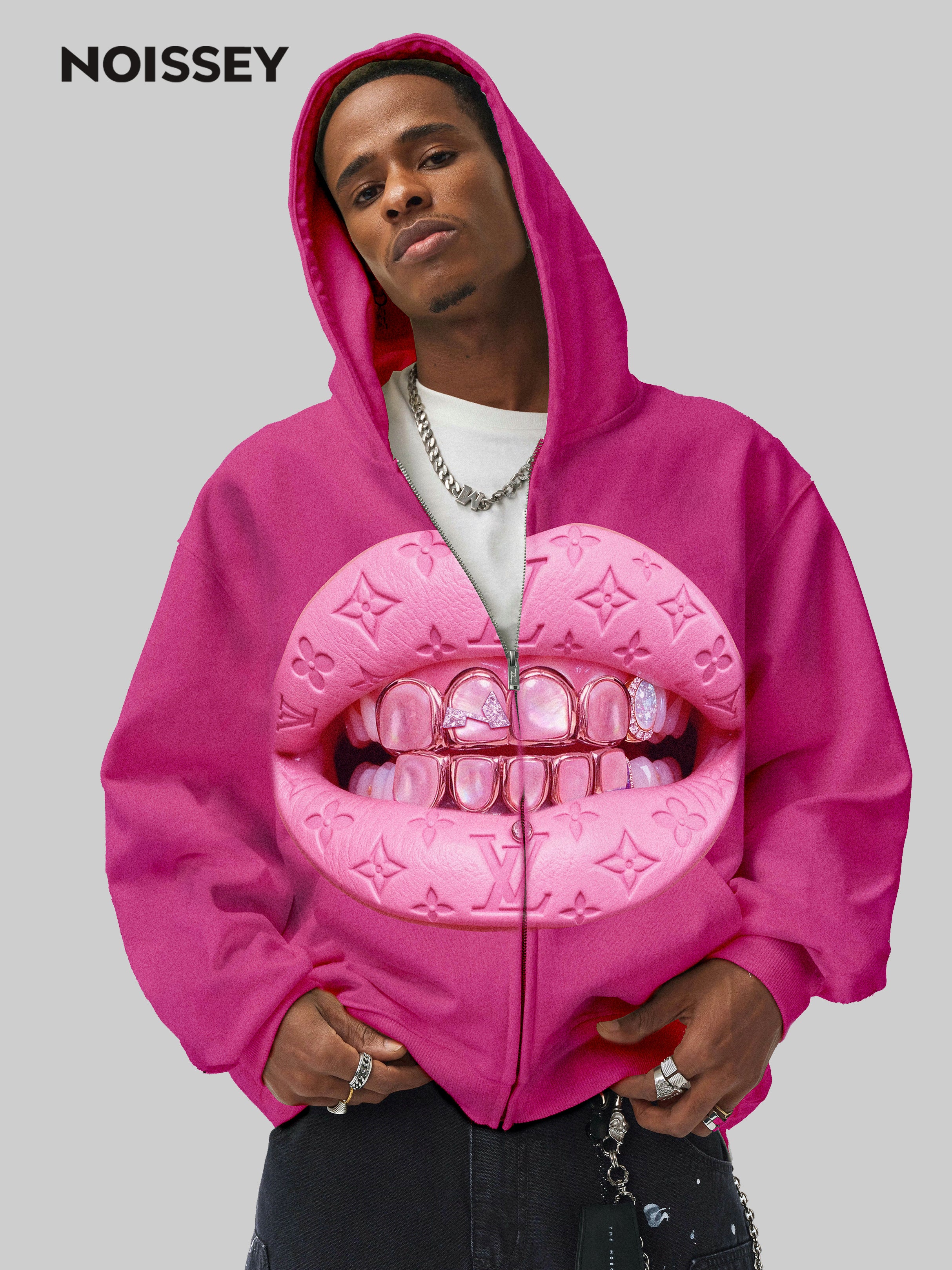 Model wearing oversized pink NOISSEY hoodie styled with cargo pants and timberlands