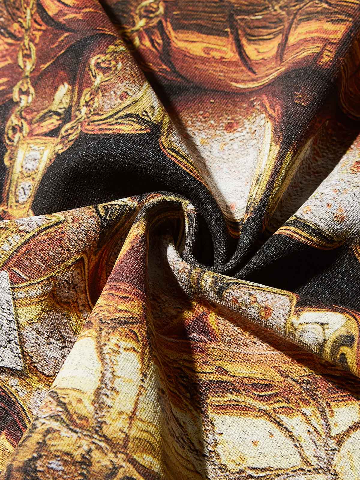 Texture shot of the beige mineral wash cotton fabric with gold graphic details