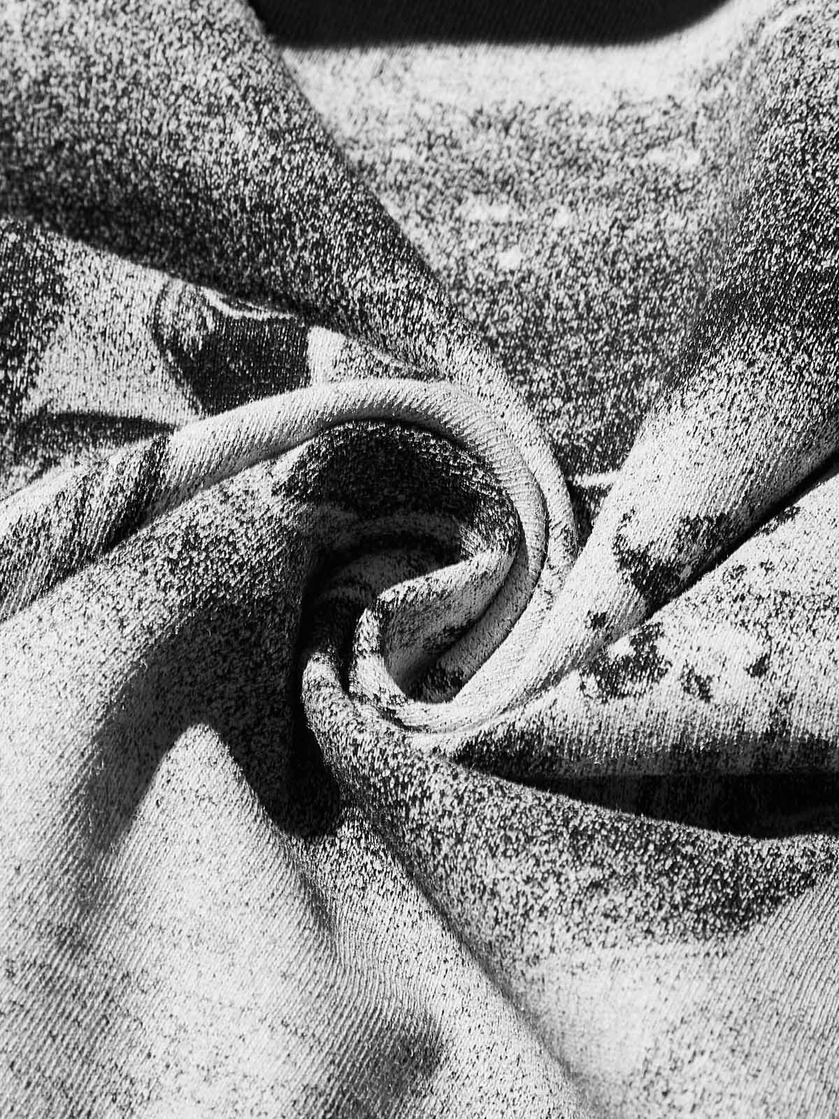 Texture shot of the black cooling fabric showing the metallic grillz print quality