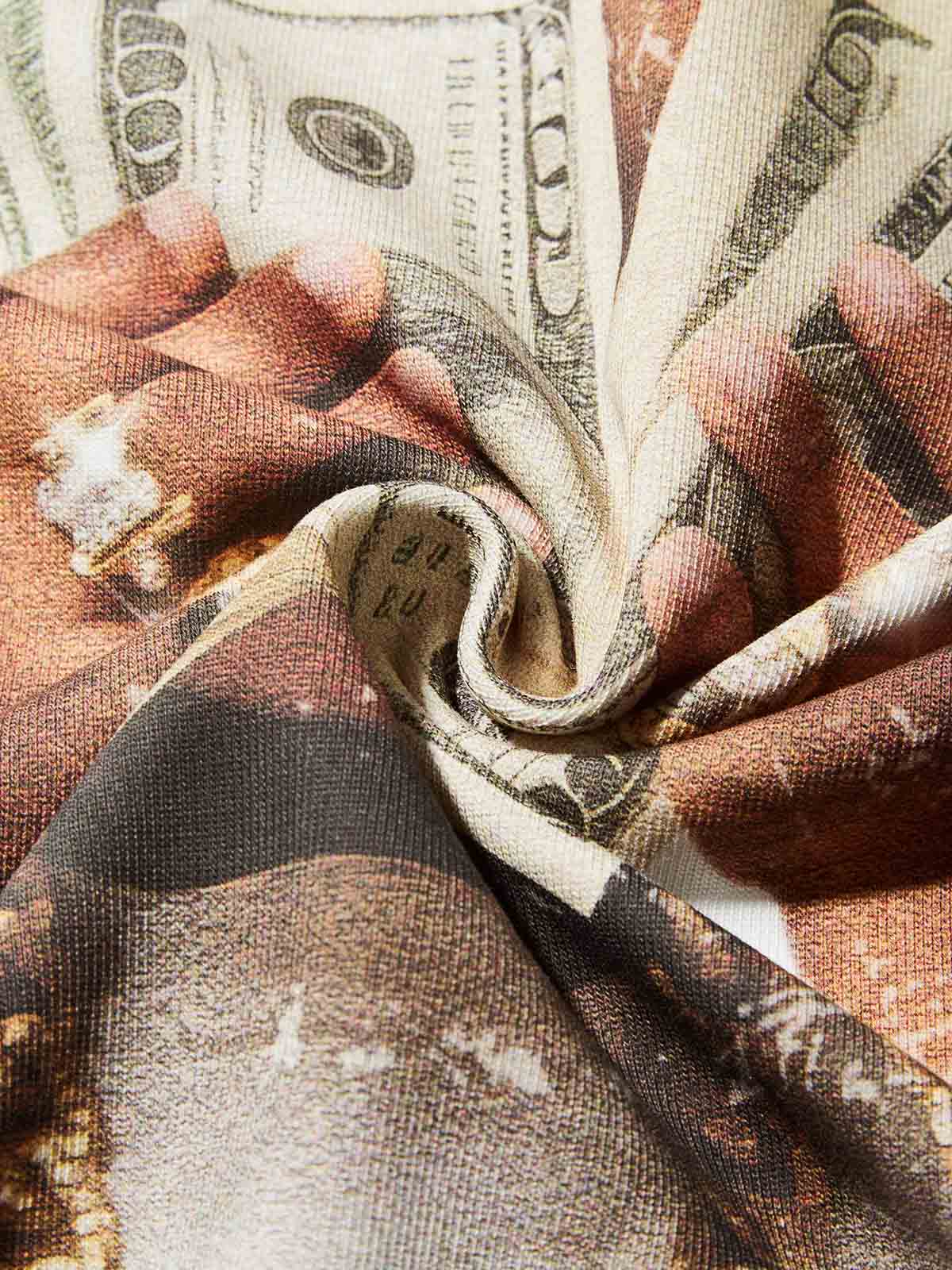 Texture shot of the graphic print showing details of gold rings and cash texture