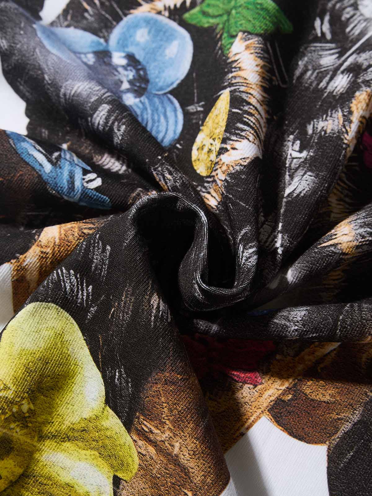 Texture shot of the white cooling fabric showing the vibrant colors of the hair accessories print